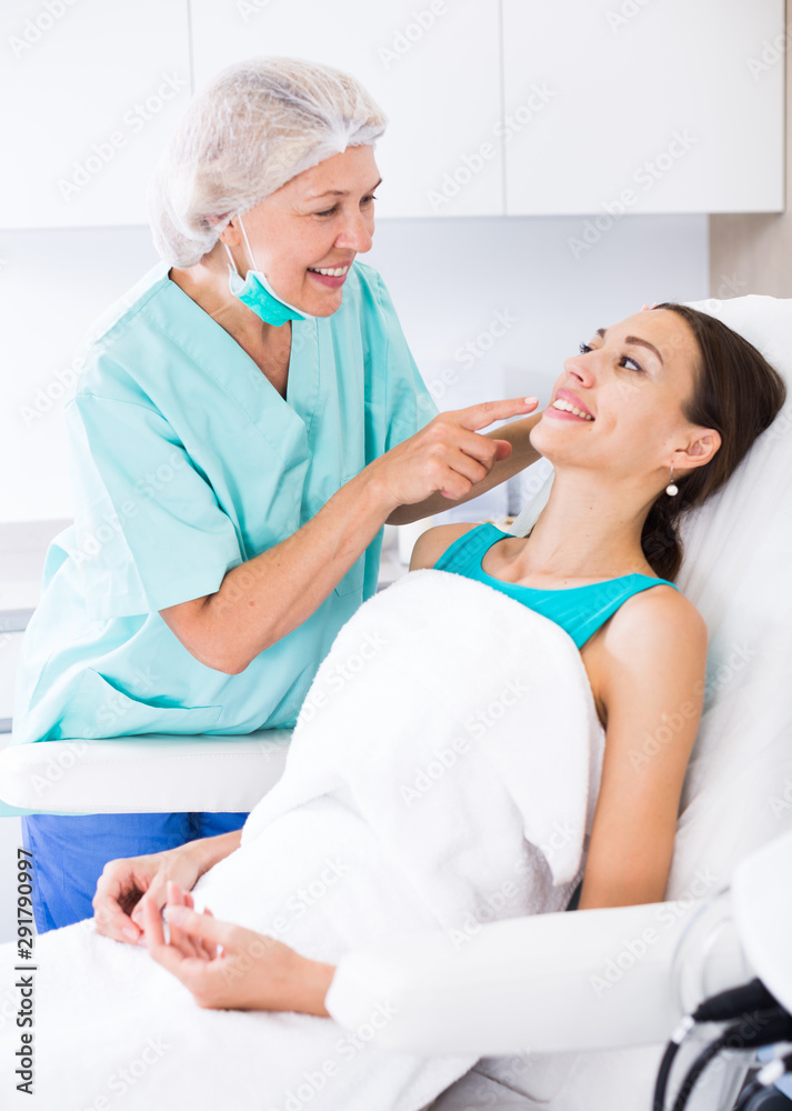Fototapeta premium Doctor beautician discussing with woman