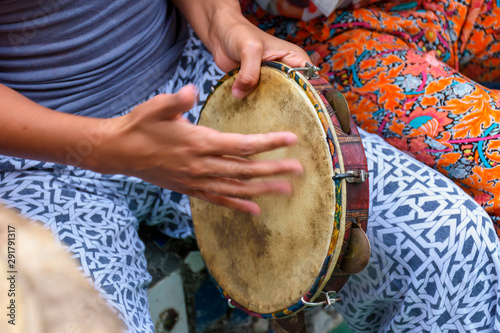 Fotografie, Obraz Woman's hands playing tambourine during capoeira performance from brazil