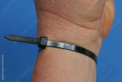 black plastic coupler on a hand on a blue background photo