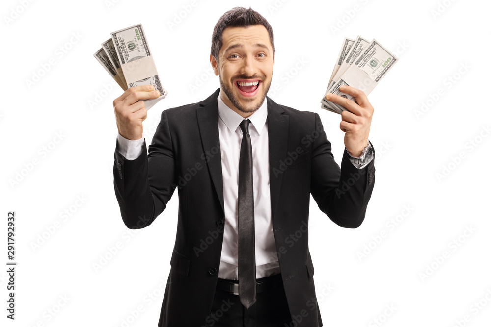Excited man in a black suit holding stacks of cash in both hands Excited man in a black suit holding stacks of cash in both hands