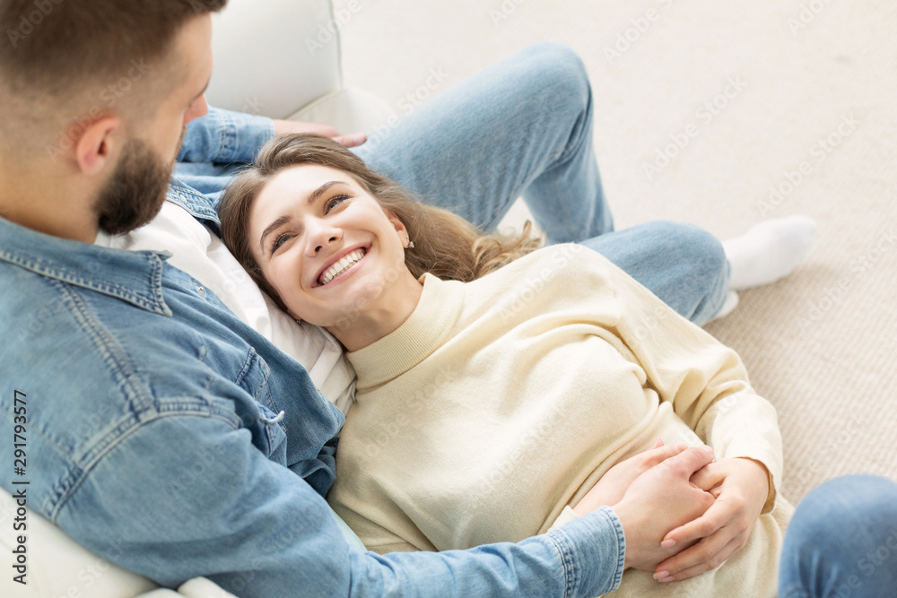 Loving couple relaxing on sofa, cozy warm leisure day Loving couple relaxing on sofa, cozy warm leisure day