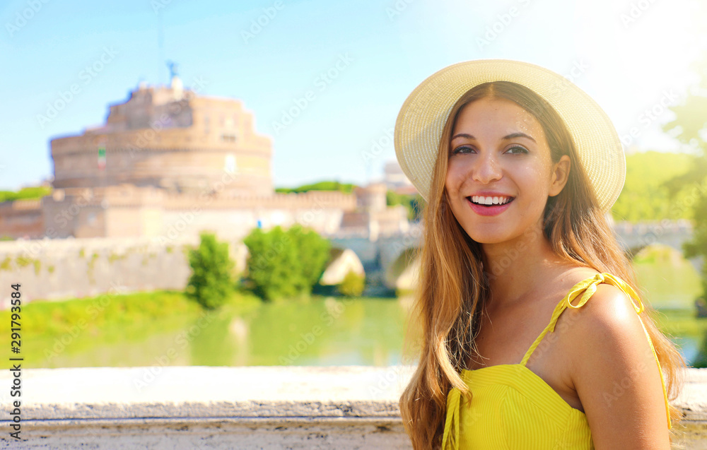 Smiling beautiful tourist girl in Rome, Italy. Attractive fashion young woman with Castel Sant Angelo castle on the background.