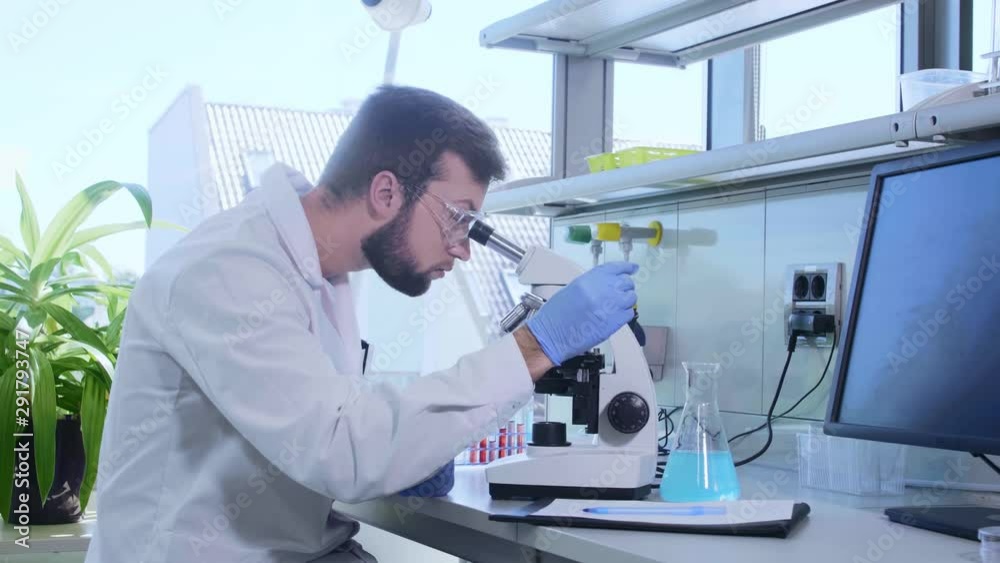 Scientist working in lab. Doctor making microbiology research. Laboratory tools: microscope, test tubes, equipment. Biotechnology, chemistry, bacteriology, virology, dna and health care.