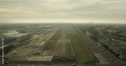 Helicopter aerial moving forward closer to landing strip, sundown