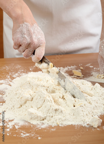 A baker cutting butter. Making Pastry Dough for Hungarian Cake. Series.