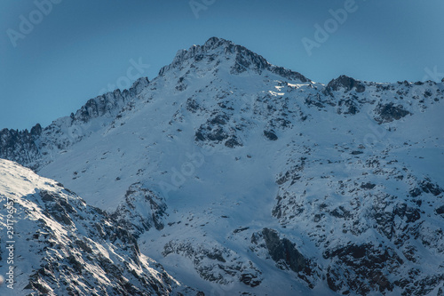 Rocky ridge above snowy valley