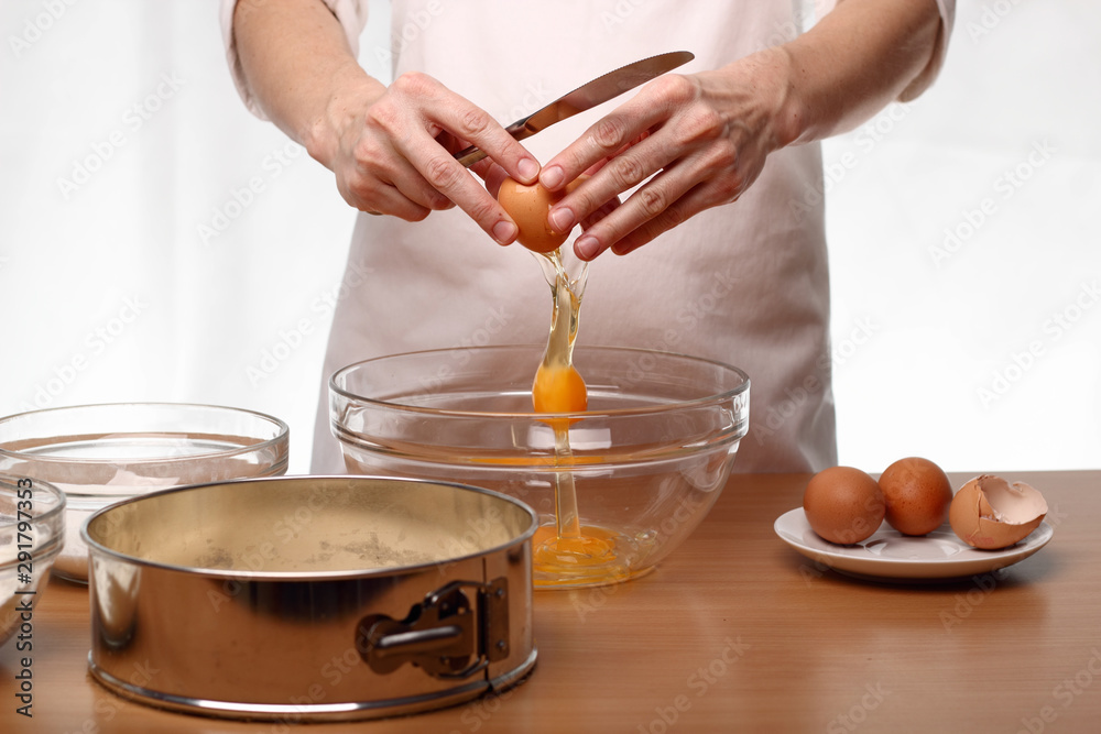 Baker cracking an egg. Making Victoria Sponge Cake. Series. Baker cracking an egg. Making Victoria Sponge Cake. Series.