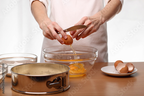 Baker cracking an egg. Making Victoria Sponge Cake. Series.