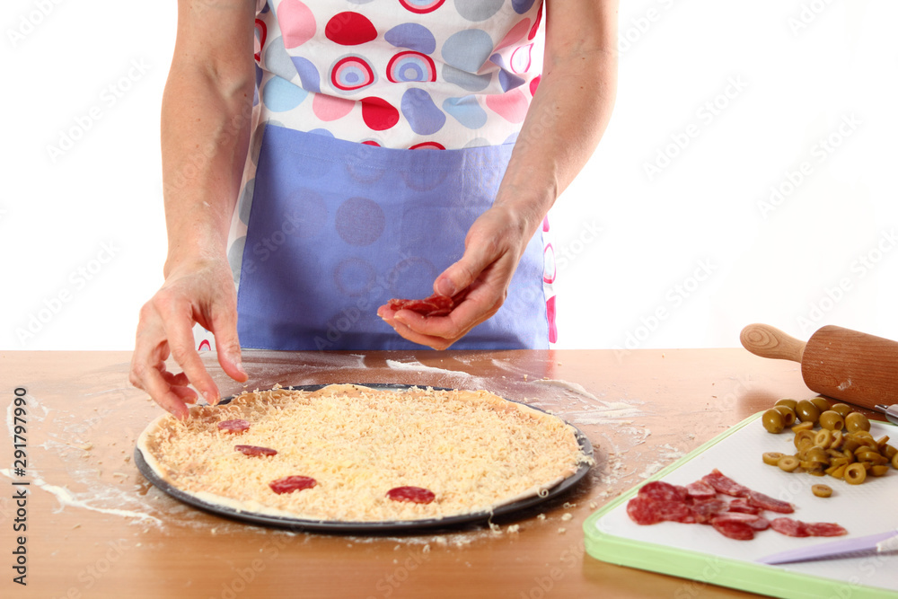 Spreading Salami on Dough Sheet. Making Pizza with Salami, Olives and Cheese. Series. 