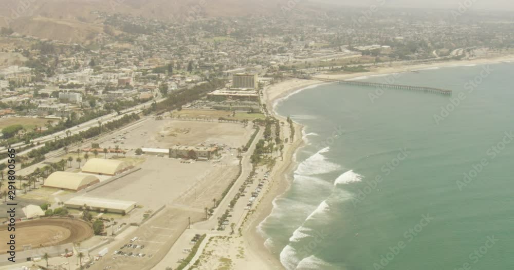 Helicopter aerial shot above beach and pier, cloudy day Helicopter aerial shot above beach and pier, cloudy day