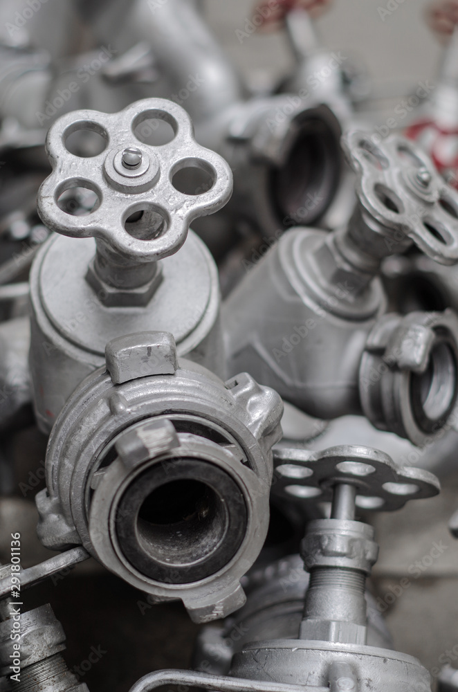 Industrial valves with red wheels. close-up of pipe valve connection Industrial valves with red wheels. close-up of pipe valve connection