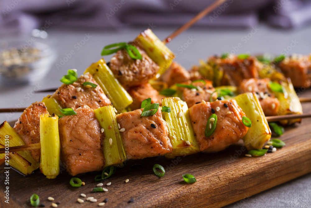 Grilled salmon skewers. Salmon fish with leeks on skewers