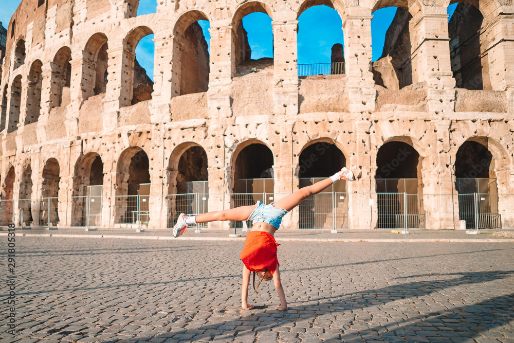 Little girl in front of colosseum in rome, italy