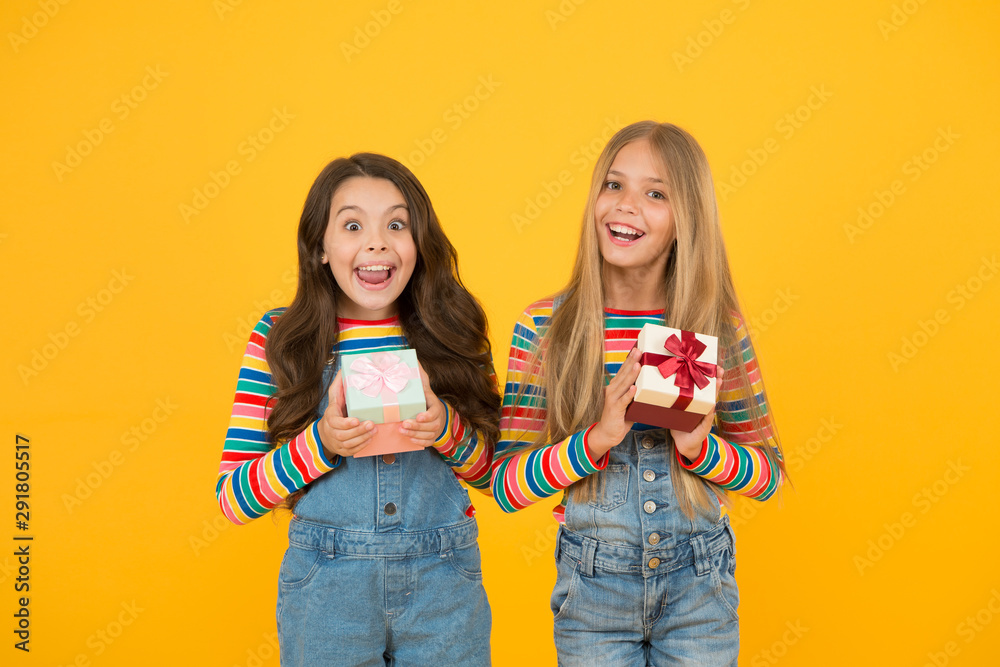 Thankful for every gift of fate. Teaching kids be thankful. Children hold gift boxes yellow background. Kids delighted gifts. Girls celebrate holiday. Happy friends. Being thankful for everything