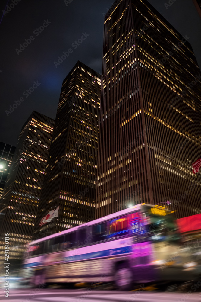 traffic in the city at night blur bus riding fast autobus building architecture view downtown manhattan new york city travel urban exploration adventure walking sign office corporate financial