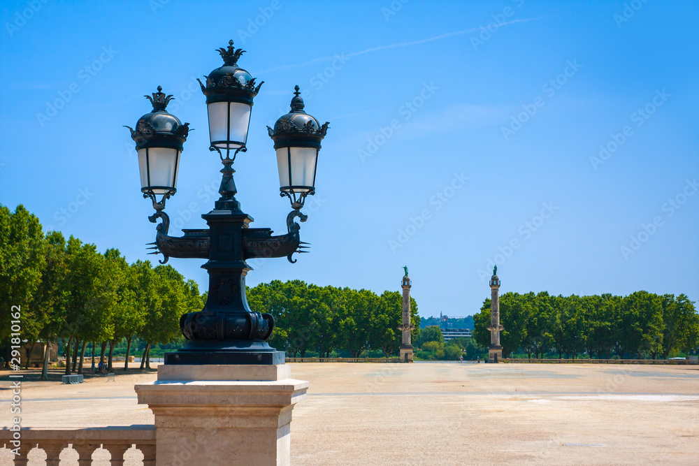 Antique street lamp and columns near the Girondins memorial in Bordeaux, France