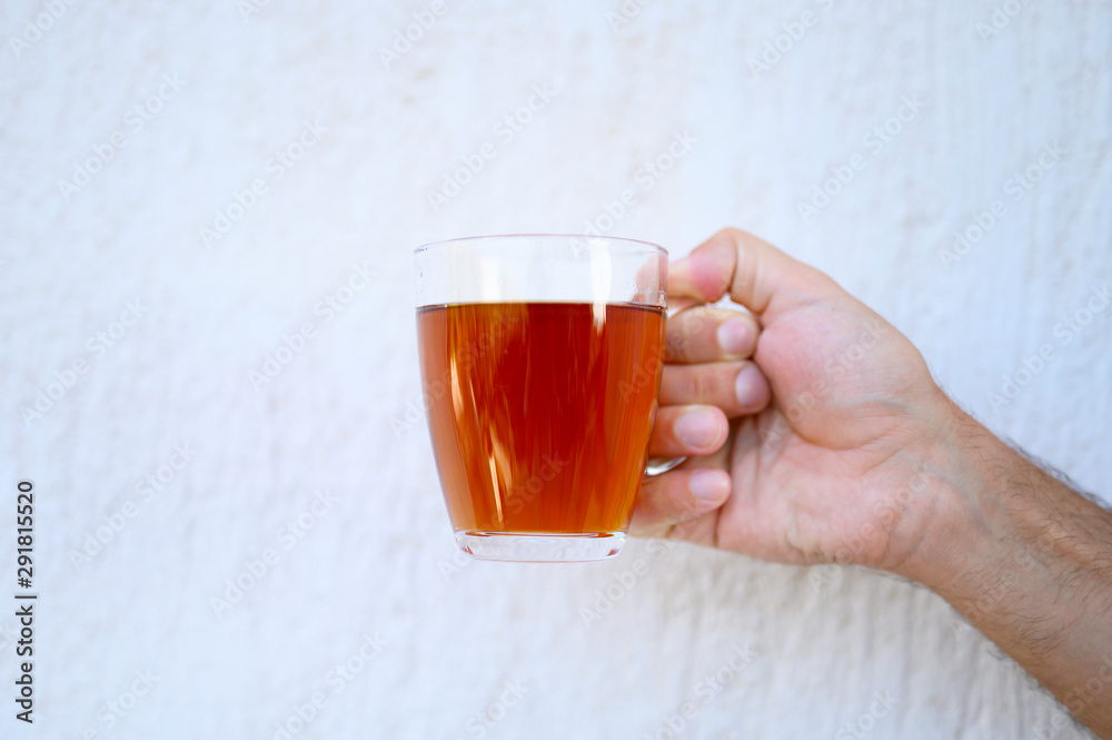 glass cup of tea in the male hand glass cup of tea in the male hand