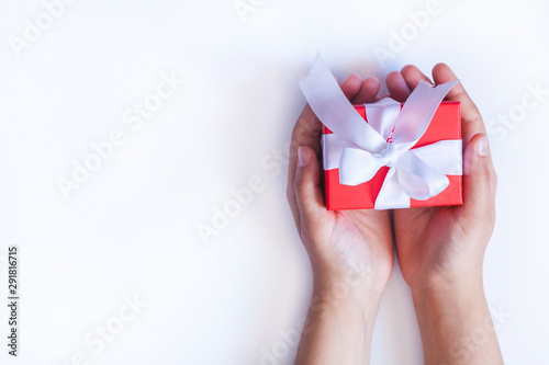 Gift in female hands. Woman hands holding a giftbox, present or surprise