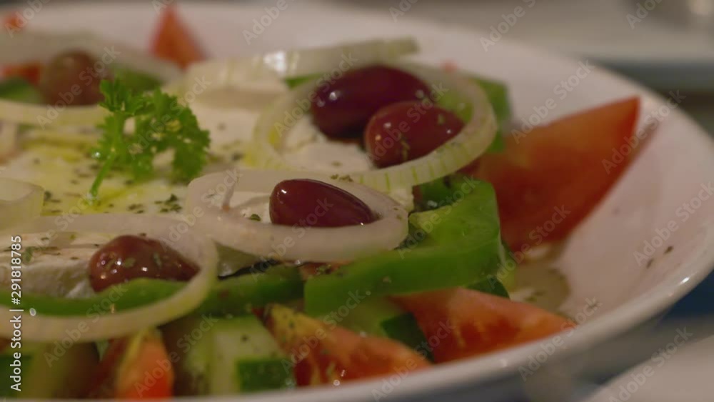 Tilt down to reveal a close up of a vegetable and fruit dish on a plate Tilt down to reveal a close up of a vegetable and fruit dish on a plate