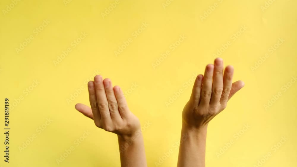 Closeup of female hands making gesture Come closer on the background yellow paper. Body language concept. With place for text or image, promotional content. Advertising area, workspace mock up