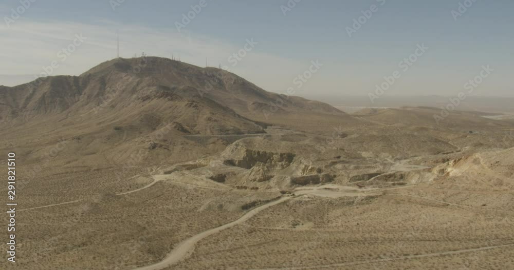Aerial shot, day, lone desert mountain and distinct ridges at the base, drone Aerial shot, day, lone desert mountain and distinct ridges at the base, drone