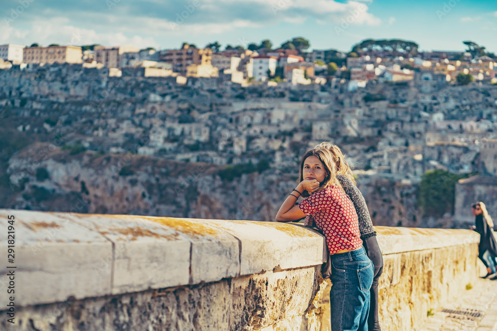 Fototapeta premium happy tourist travelling in south of italy, posing in a selfie photo in Matera, Basilicata, unesco site, capital of culture 2019