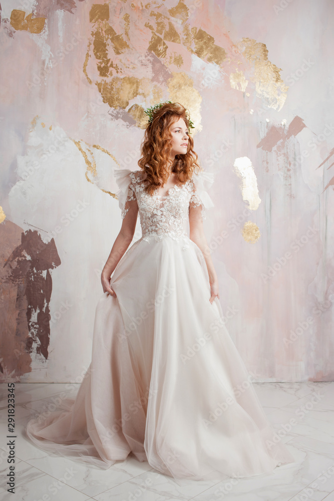 Elegant red-haired girl bride. Young beautiful woman in wedding dress Elegant red-haired girl bride. Young beautiful woman in wedding dress