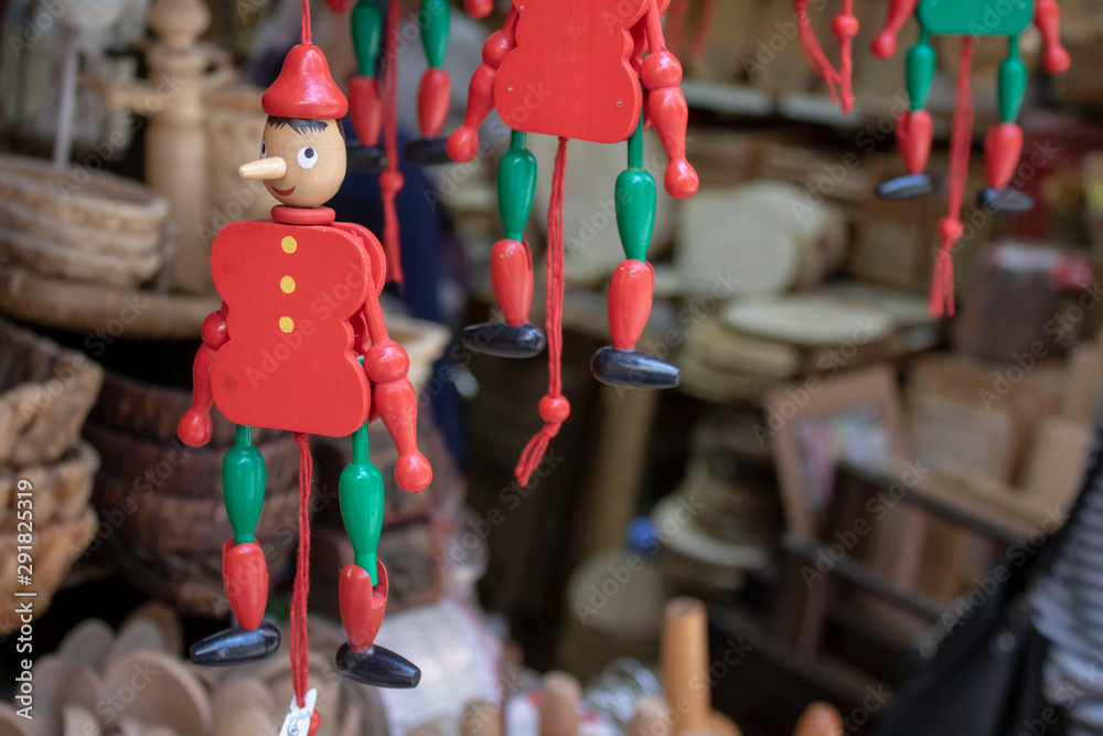 Puppet pinocchio made of wood. Store selling wooden handmade products. filmed in front of him. Puppet pinocchio made of wood. Store selling wooden handmade products. filmed in front of him.