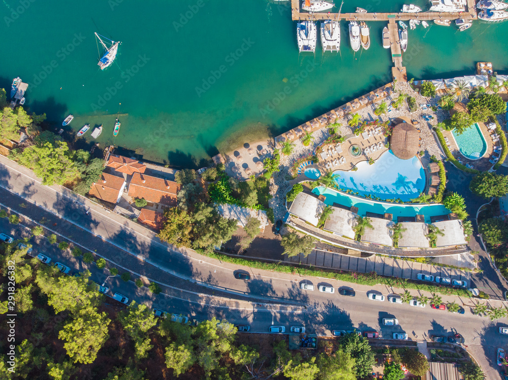 Marina and pier with yachts, seaside town on the beach, hotel and swimming pools. Marina and pier with yachts, seaside town on the beach, hotel and swimming pools.