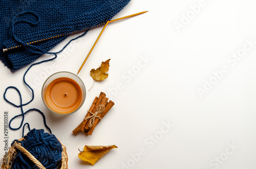 Autumn composition. knitting candle cinnamon flat lay, top view.