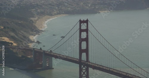 Aerial shot, day, zoom on golden gate bridge and resedential area behind, drone photo