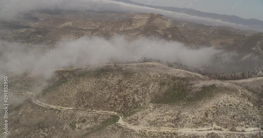 Aerial shot, day, high altitude shot of clouds coasting above coastal california mountaintop, drone Aerial shot, day, high altitude shot of clouds coasting above coastal california mountaintop, drone