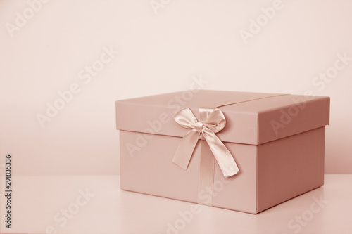 gift in box with satin ribbon and bow, concept of valentines day, christmas presents, mother's day, new year, close-up, copy space
