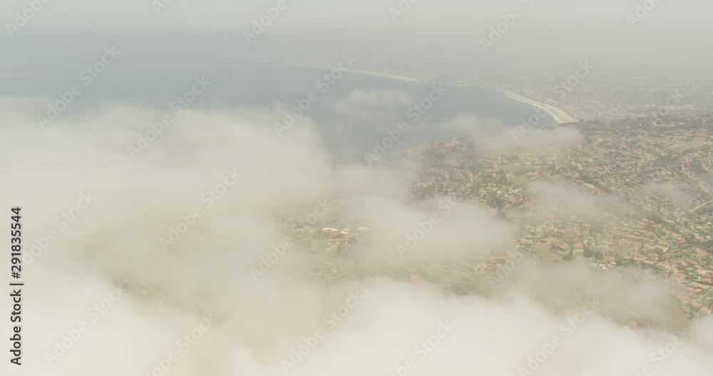 Aerial shot, day, high altitude view of long beach coast under cloud covers, drone Aerial shot, day, high altitude view of long beach coast under cloud covers, drone
