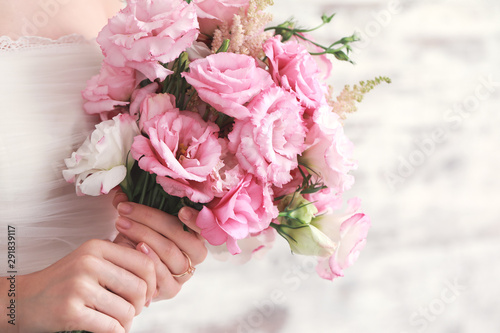 Beautiful young bride with wedding bouquet, closeup