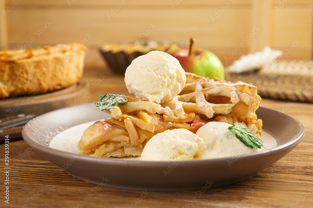 Plate with slice of tasty apple pie and ice cream on wooden table Plate with slice of tasty apple pie and ice cream on wooden table