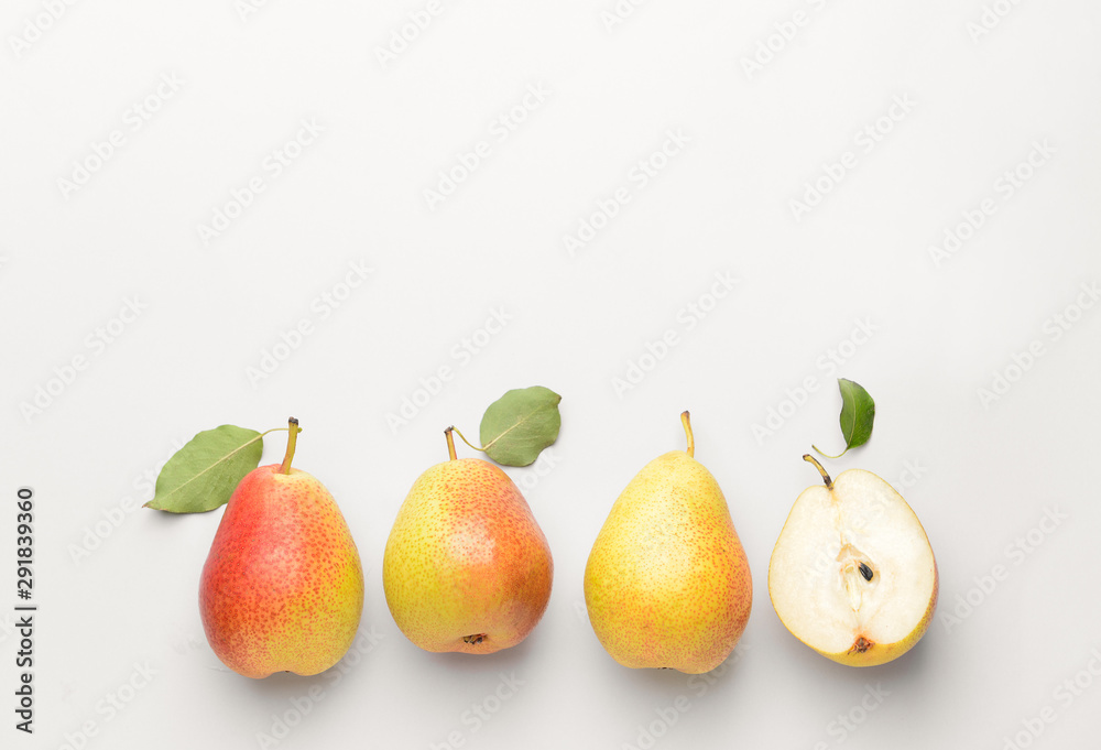 Whole pears and one half on white background. Concept of uniqueness