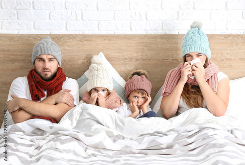 Family ill with flu in bed ...