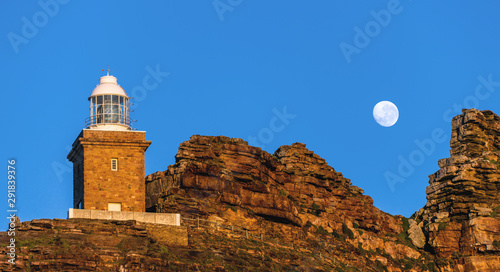 Lighthouse Cape of Good hope and moon in blue sky. South Africa.