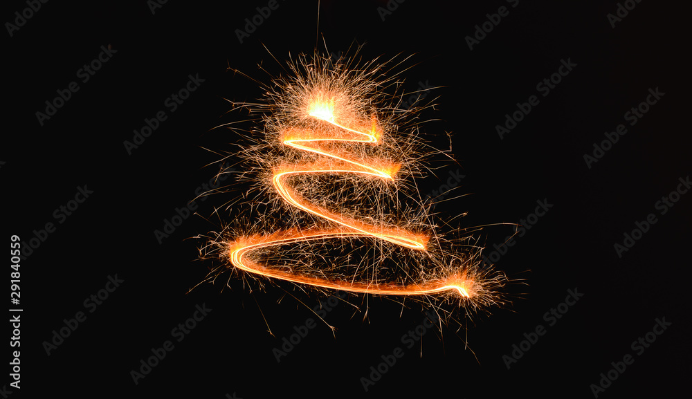 Shining spiral made of sparklers on dark background