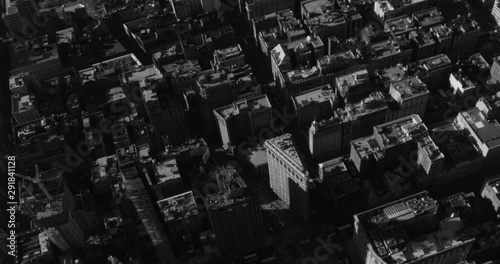 Black and white aerial shot, zoom in on Flatiron building, end pan on Madison Square park, drone