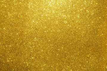gold Sparkling Lights Festive background with texture. Abstract Christmas twinkled bright bokeh defocused and Falling stars. Winter Card or invitation