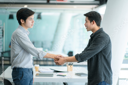 Business people shaking hands at the office. Success teamwork, partnership and handshake business concept