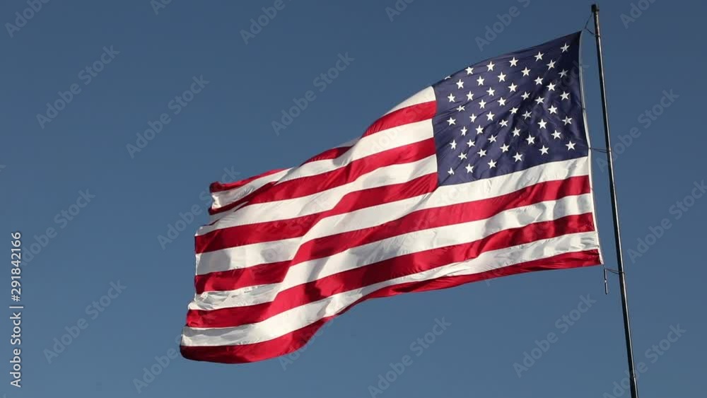 Full HD Left Facing American Flag Slow Motion Waving In Wind With Ghosted Time-lapse Clouds Full HD Left Facing American Flag Slow Motion Waving In Wind With Ghosted Time-lapse Clouds