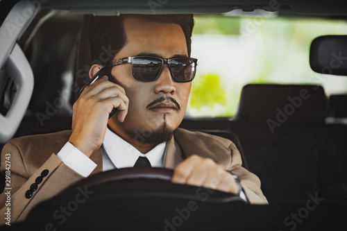 usiness man talking with mobile phone and driving a car © geargodz