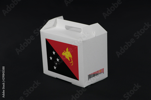 Papua New Guinea flag on white box with barcode and the color of nation flag on black background. The concept of export trading from Papua New Guinea.