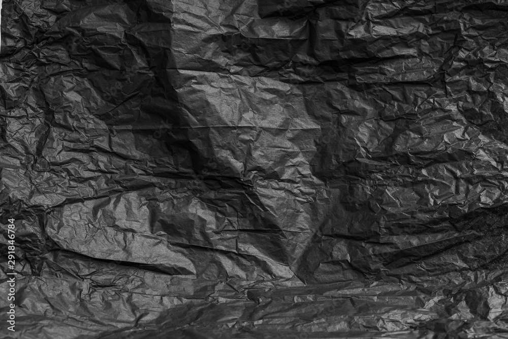 Fototapeta premium Crumpled black paper use for background