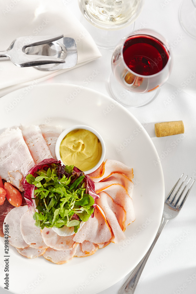 Gourmet, restaurant, delicious dinner food - close up of Sliced Meats with Rocket Salad and Tomatoes