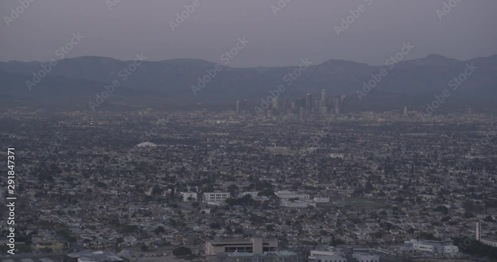 Aerial shot, low light, Downtown Los Angeles and mountains in background, surrounding Los Angeles in foreground, drone Aerial shot, low light, Downtown Los Angeles and mountains in background, surrounding Los Angeles in foreground, drone