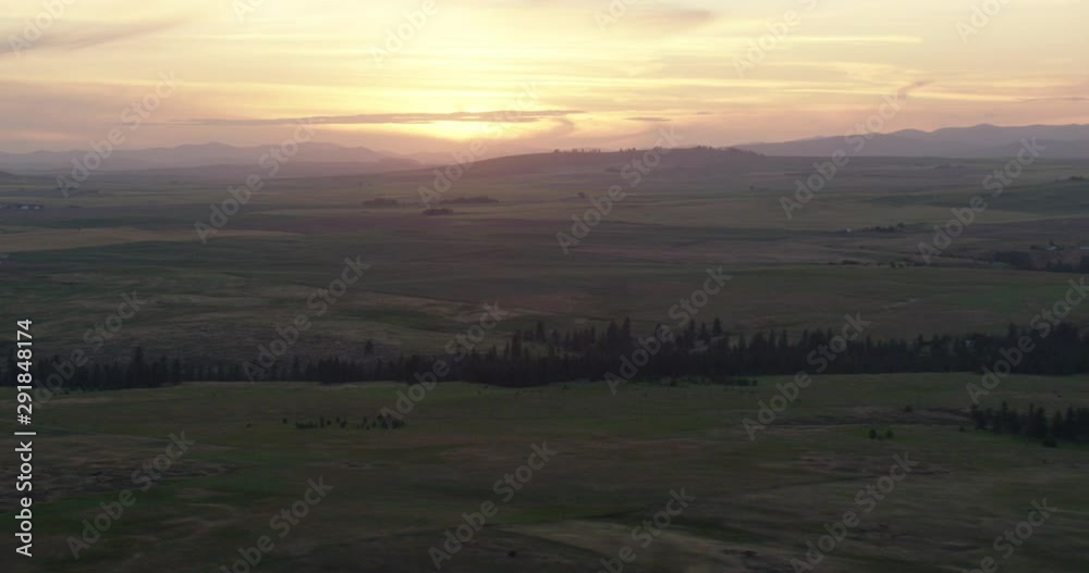 Sun setting over green lands, helicopter aerial, drone Sun setting over green lands, helicopter aerial, drone